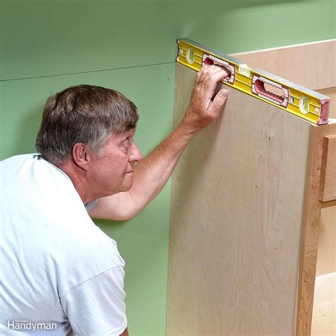 Use a cordless screwdriver to secure the cabinets together. How to Install Cabinets Like a Pro | Installing kitchen cabinets, Kitchen base cabinets ...