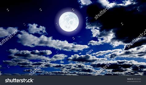 The Bright Big Moon On Dark Blue Night Sky With Clouds