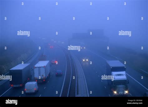 Traffic Travelling On The A1m Motorway In Thick Fog Leeds Yorkshire Uk