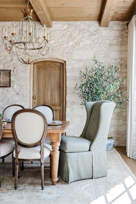 Dining Room With Rustic Stone Wall And Wood Ceiling Beams French