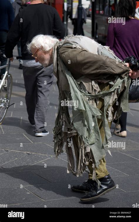 Down And Out Tramp Hobo Wearing Very Ragged Clothing In The Centre Of Edinburgh Scotland Stock