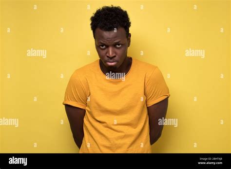 Young African American Man Looking Down With Guilty Confused Expression