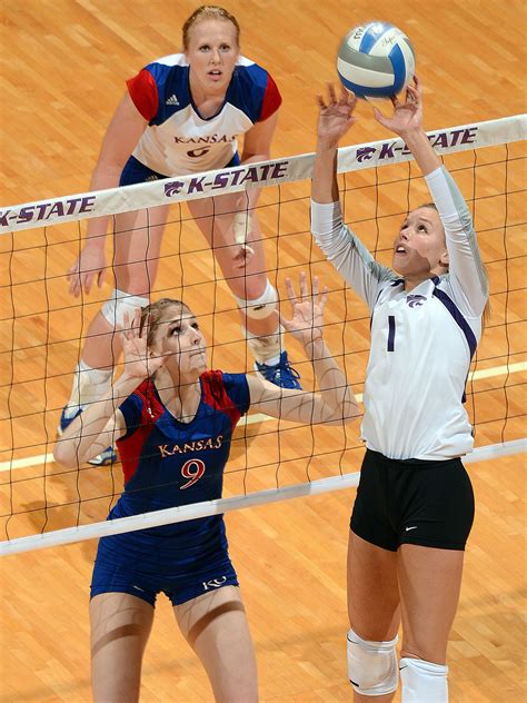 Two Female Volleyball Players Trying To Block The Ball