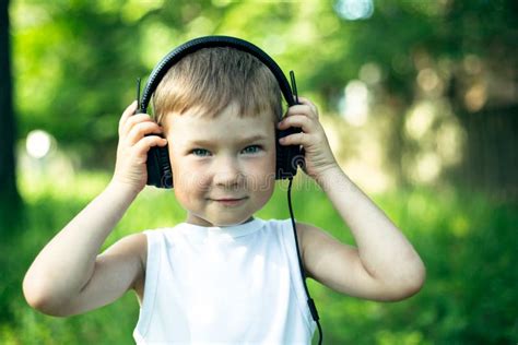 Little Boy Enjoying Music In Headphones Outdoors Stock Image Image