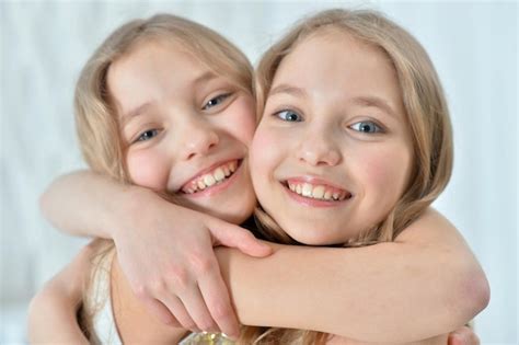 Premium Photo Portrait Of Cute Twin Sisters Hugging