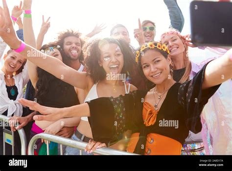 Young Friends In Audience Behind Barrier At Outdoor Music Festival