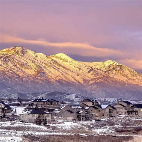Square Homes On Snowy Hill Against Frosted Wasatch Mountain With Golden