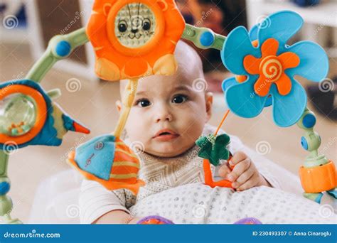 Cute Chubby Baby Playing With Colorful Toys Sweet Infant At Home Stock
