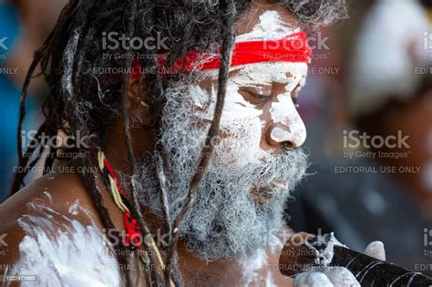 Portrait Of Aboriginal Male With Dreadlocks And Didgeridoo Background