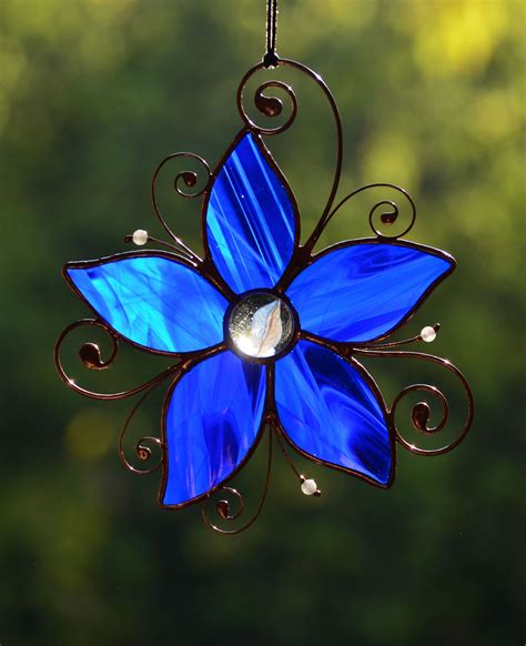 A Blue Glass Flower Hanging From A Chain