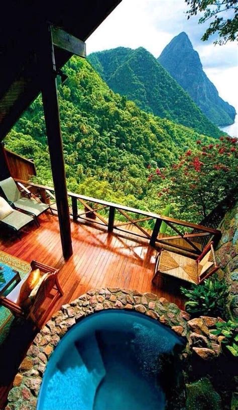 An Outdoor Hot Tub Sitting On Top Of A Wooden Deck Next To A Lush Green