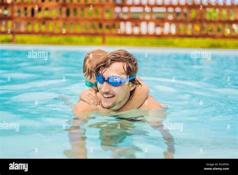 Dad And Son In Swimming Goggles Have Fun In The Pool Stock Photo Alamy