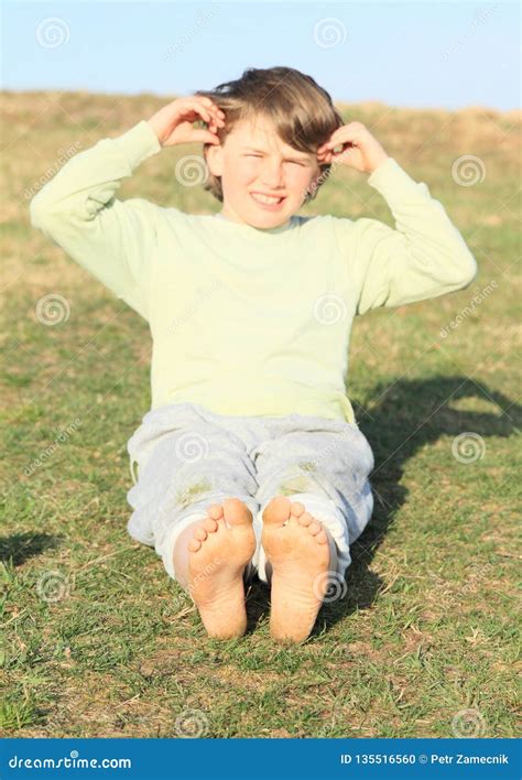 Boy Sitting On Meadow Stock Photo Image Of Grinning 135516560