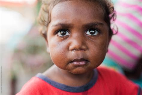 Little Aboriginal Girl Looking Upwards By Stocksy Contributor Gary