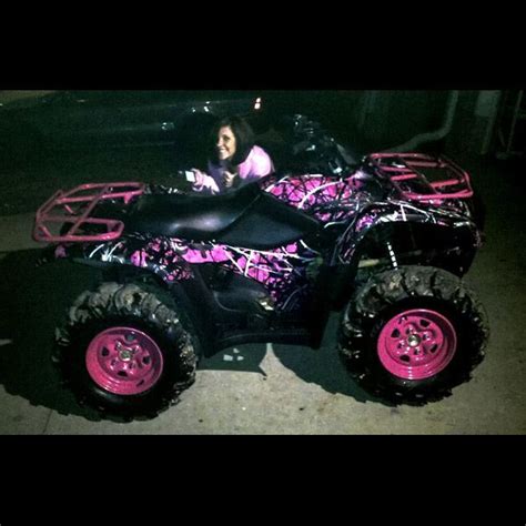 A Person Riding An Atv With Pink Wheels