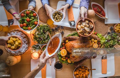 Above View Of Passing Food During Thanksgiving Dinner High Res Stock