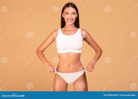 Slim Woman In White Underwear Demonstrating Her Perfect Slender Body