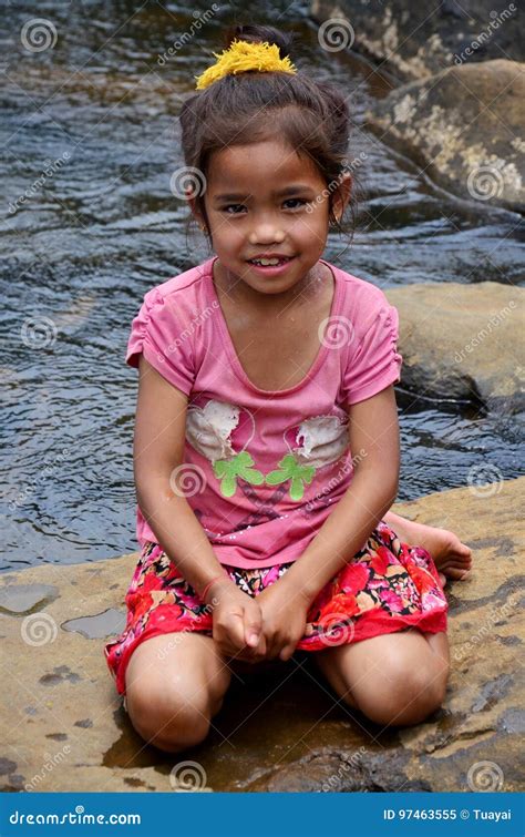 laotian girl setting out rice cakes to dry in vientianne editorial photo