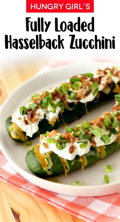 A White Plate Topped With Cucumbers Covered In Cheese And Toppings On