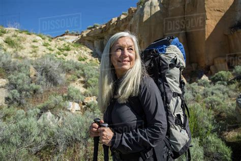 Older Caucasian Woman Hiking With Backpack Stock Photo Dissolve