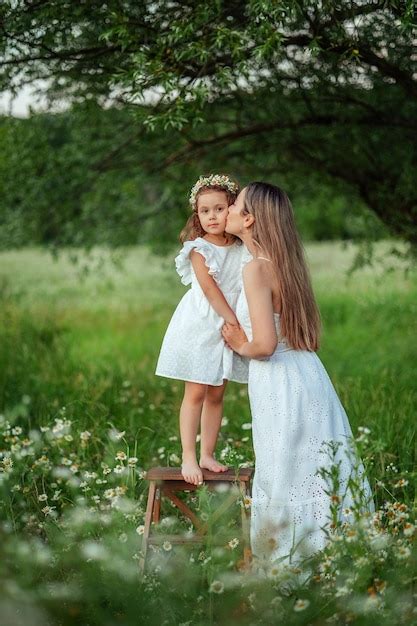 Premium Photo Beautiful Mom Her Little Daughter In White Dresses Have Fun On A Walk In Summer