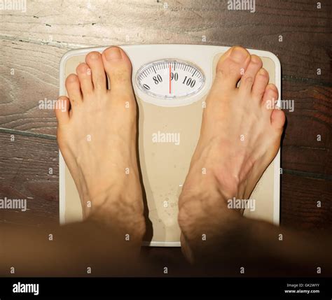 Man Standing On Scales In Bathroom About 90 Kg Stock Photo Alamy
