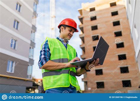 Engineer Builder With Laptop Computer At Construction Site Stock Photo