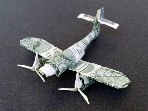 An Origami Airplane Made Out Of One Dollar Bill