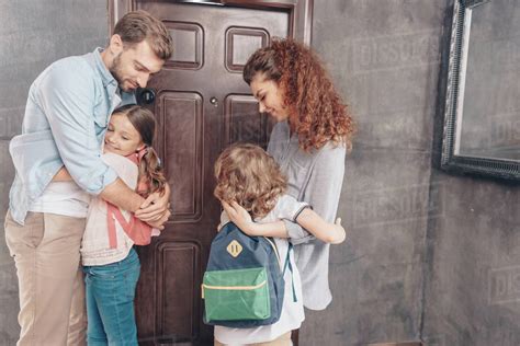 Cute Parents Hug Kids Before School Stock Photo Dissolve