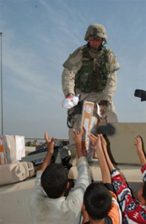 Us Army Spc Seidel Hands Out Frozen Chickens To Iraqi Citizens