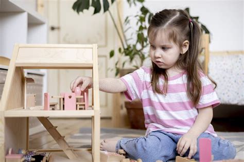 Montessori Material Child Girl In Pink T Shirt Arranges Wooden