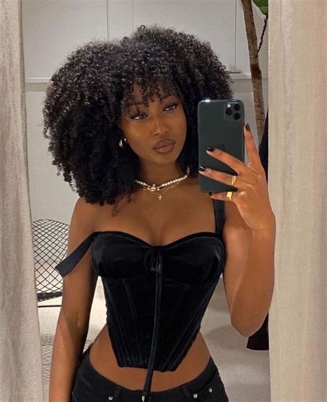 A Woman Taking A Selfie In Front Of A Mirror Wearing A Black Corset