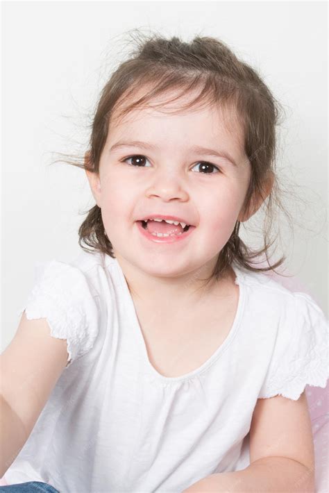 Premium Photo Portrait Of A Charming Little Girl Smiling At Camera On
