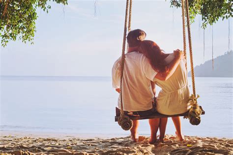 Romantic Holidays Honeymoon Affectionate Couple On Beach On Swing Stock