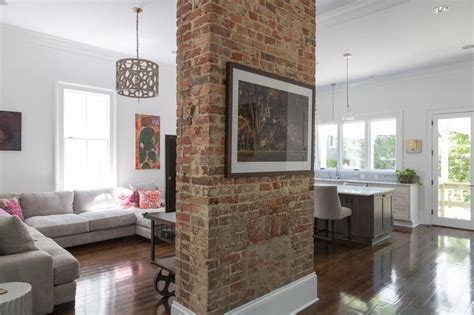 A Red Brick Column Makes A Stately Anchor In This Open Concept Living