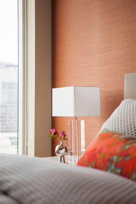 This bedroom wallpaper has a gorgeous vintage feel that would work perfectly in a traditional bedroom, but also wouldn't look out of place in a more contemporary space. Burnt orange grasscloth creates a textured accent wall in ...