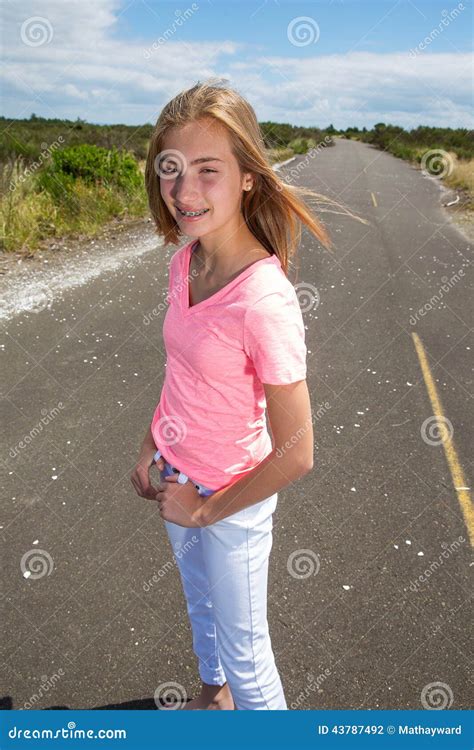 A Teenage Girl Travels Barefoot On An Empty Road Stock Photo Image Of