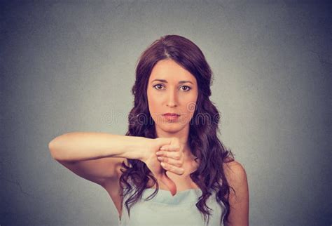 Unhappy Woman Giving Thumbs Down Gesture Looking With Negative Expression And Disapproval Stock
