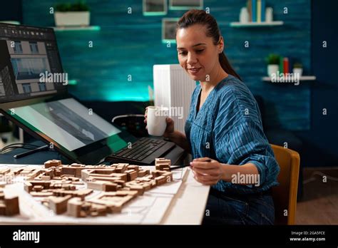 Woman With Architect Occupation Working On Blueprint Model Building