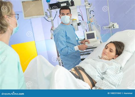 Pregnant Woman With Electronic Fetal Monitor Attached To Belly Stock