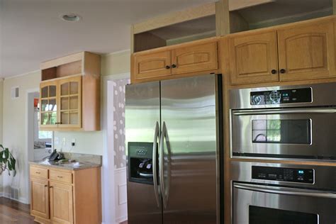 The kitchen cabinets and trim do not go to the ceiling and there is a large open area. My Kitchen Refresh: Extending My Cabinets To the Ceiling - Freshly Pieced