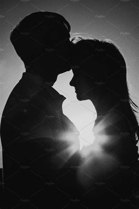 black white photography romantic silhouette couple standing and kissing on background su high