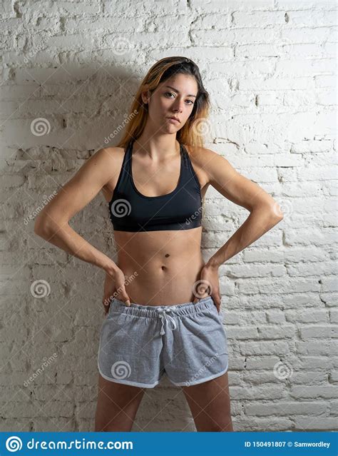 Portrait Of Sporty Beautiful Woman In Sport Clothes Looking Sensual And