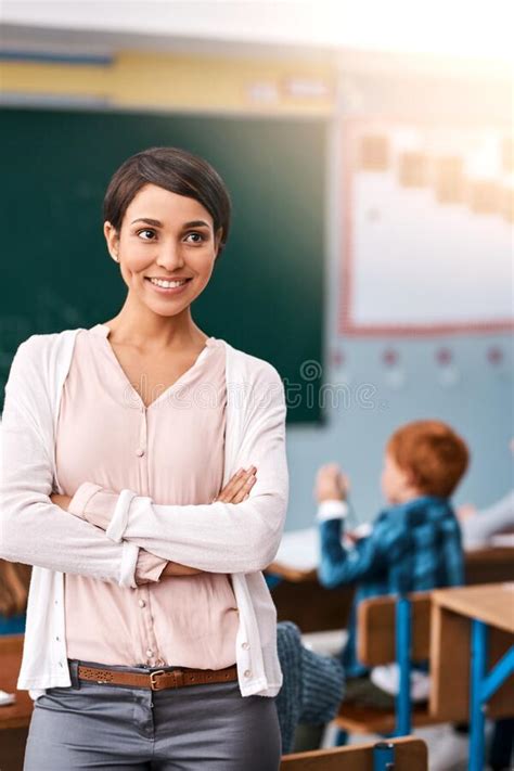 The Life Of A Teacher A Cheerful Young Female Teacher Giving Class To