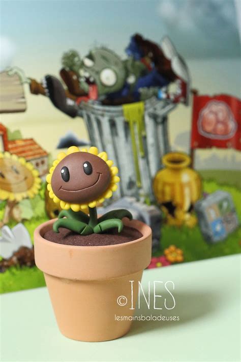 A Small Toy Sunflower Sitting On Top Of A Potted Plant