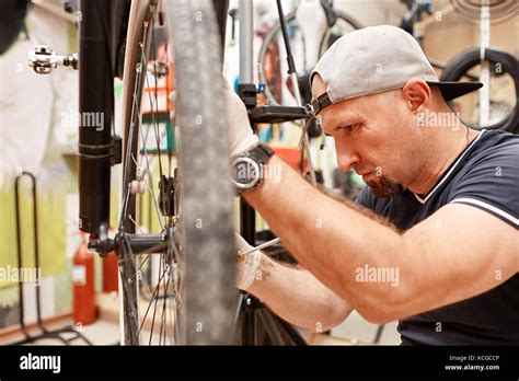 Bicycle Mechanic In A Workshop In The Repair Process Stock Photo Alamy