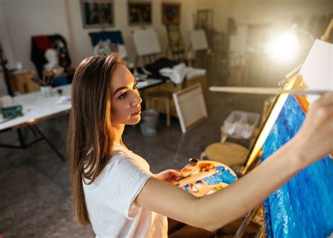 Premium Photo Woman Artist Painting A Picture On Easel With Oil