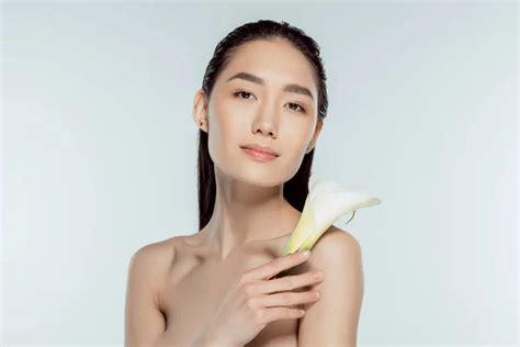 Beautiful Nude Asian Girl Posing With Calla Flower Isolated On Grey