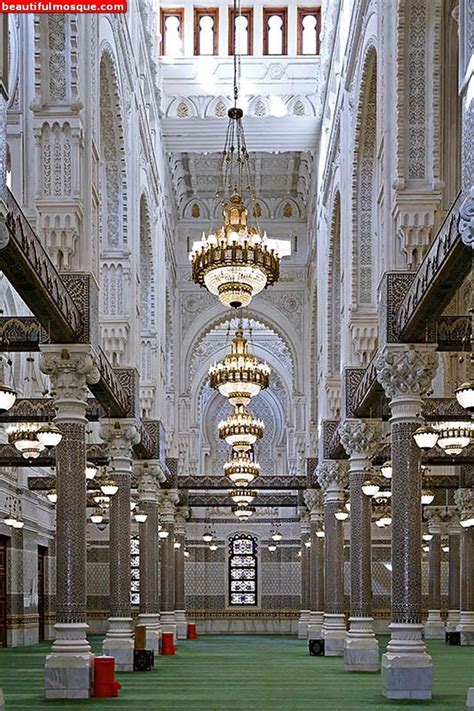The Inside Of A Large Building With Columns And Chandeliers