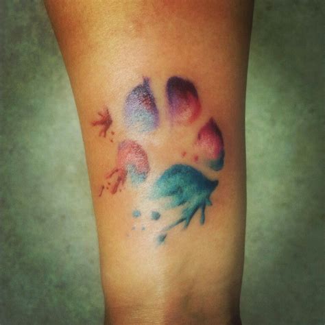 This is an interesting piece that incorporates a boot print along with two paw prints, perfectly capturing the powerful bond a growing trend in the tattoo world uses a loose composition and vibrant colors to create the effect of watercolor paint applied directly to the skin. Watercolor pawprint tattoo | Body art tattoos ...